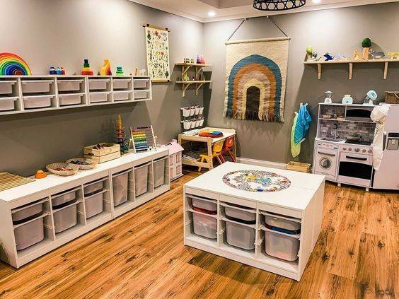 Play room featuring white storage units and a wooden floor