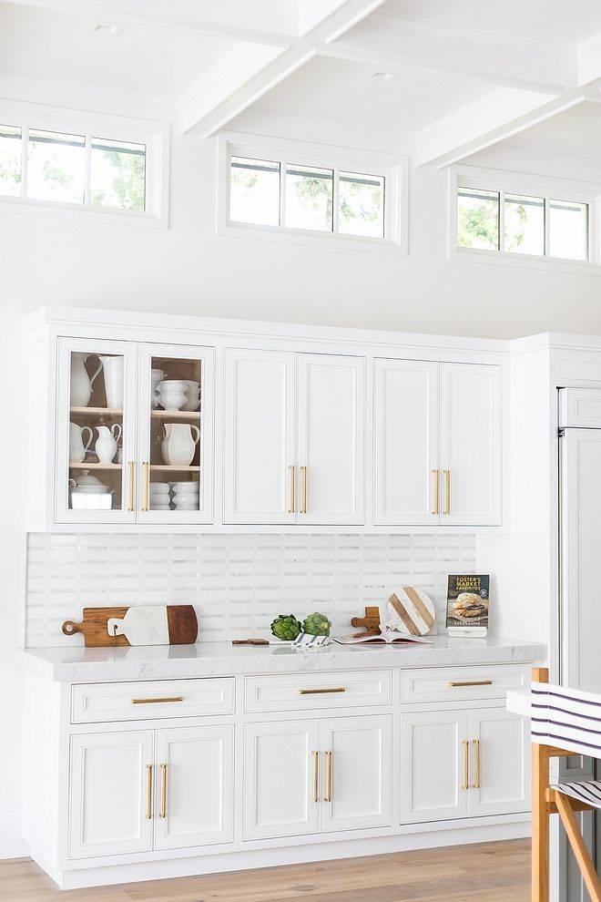 White kitchen with three transom windows at the top near the ceiling 