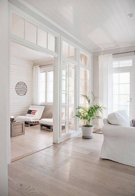 White transom windows in living room with white furniture 