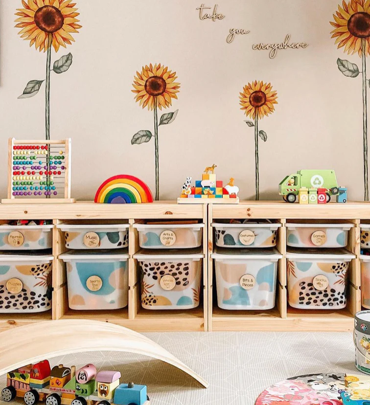 Ikea Trofast storage bins decorated with sunflowers and pink and blue decals