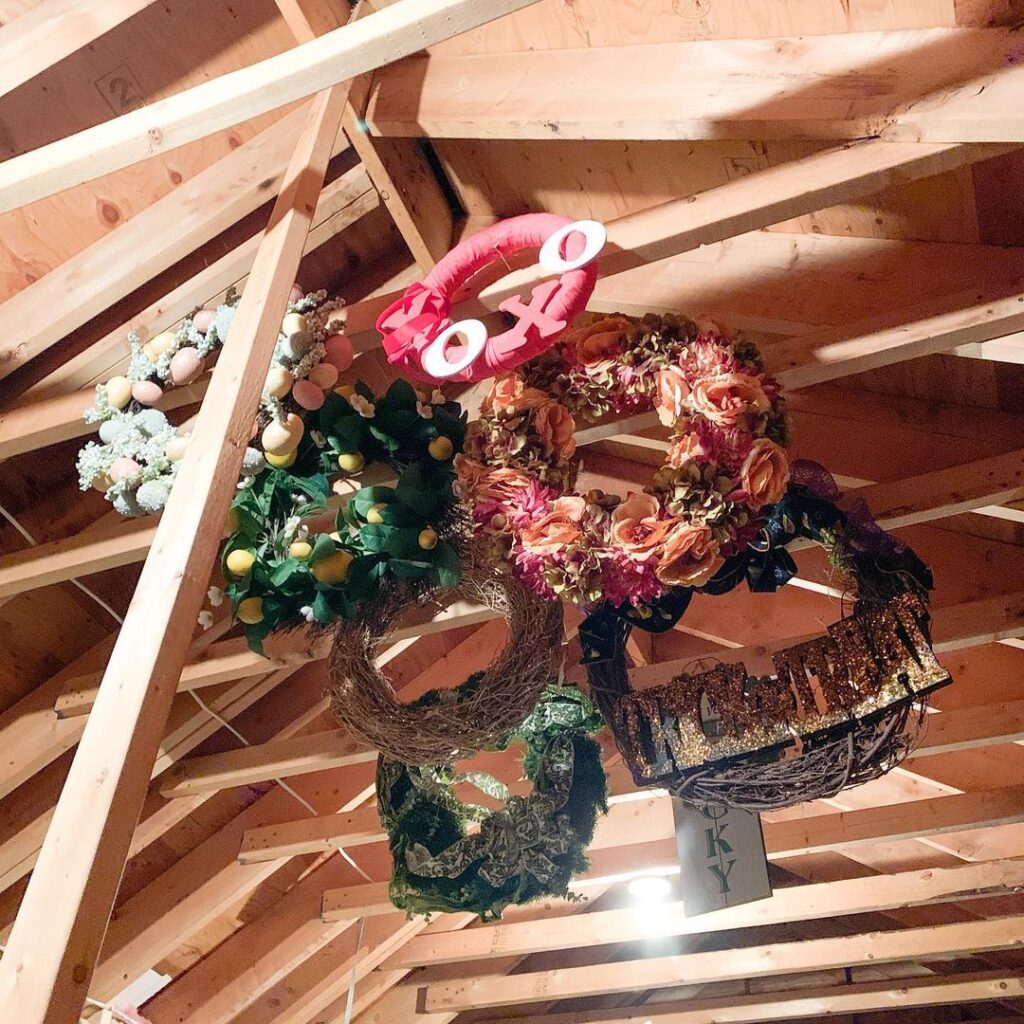 Holiday wreaths hanging at the top of attic 