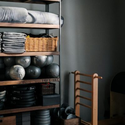Neat arrangement of gym equipment and yoga mats in a modern fitness studio.