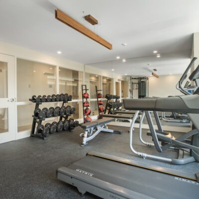 black and gray treadmill near white wall