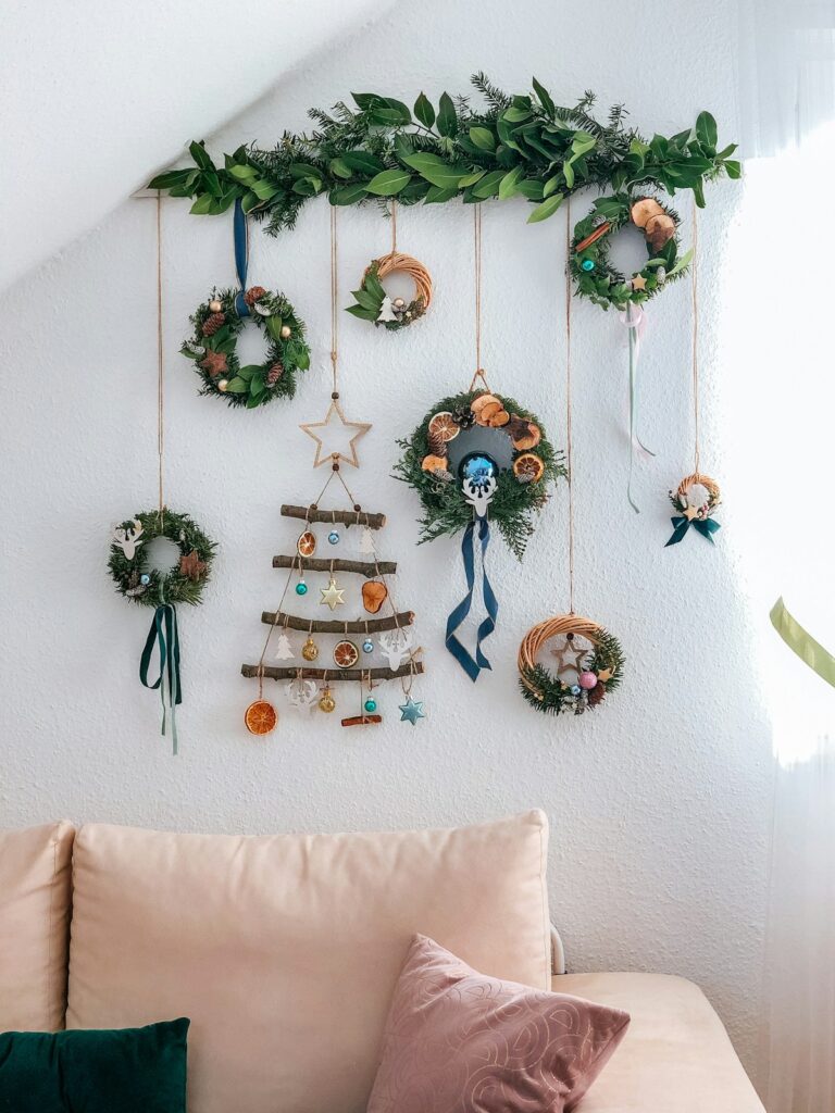 a living room with a couch and a christmas tree hanging on the wall